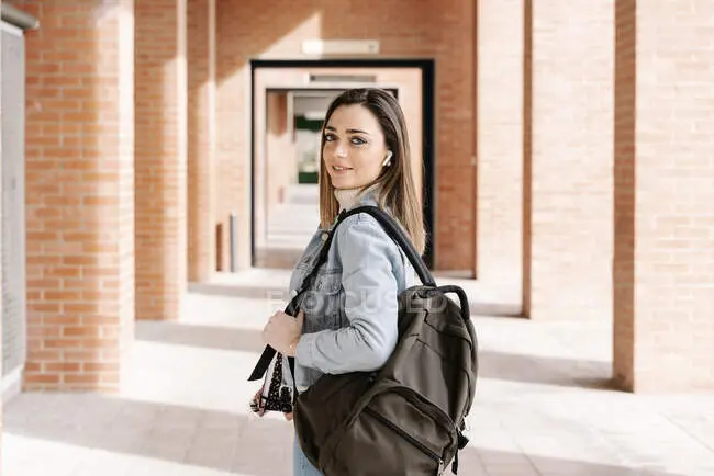 focused_479963276-stock-photo-smiling-university-student-bag-book