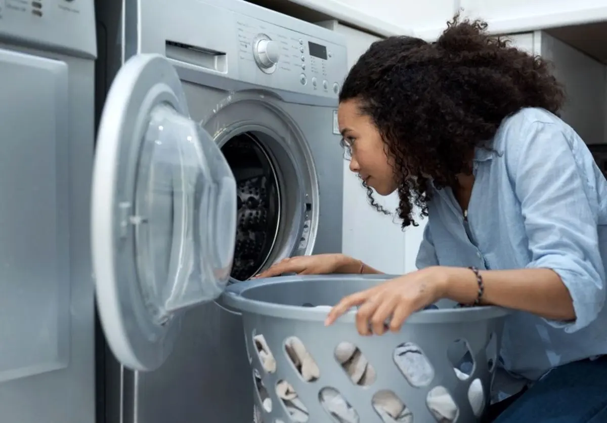 بررسی دیگ ماشین لباسشویی توسط یک خانم