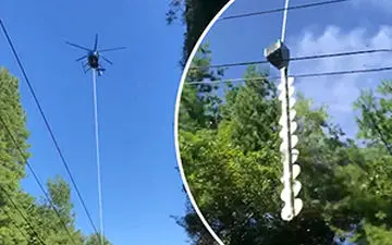 بریدن شاخه‌های مزاحم درختان با هلی‌کوپتر